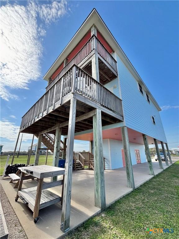 surrounding community with fence, a lawn, stairway, and a patio