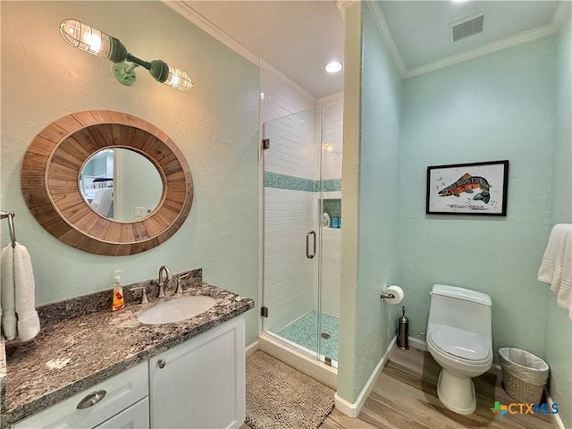 bathroom featuring vanity, visible vents, baseboards, ornamental molding, and a shower stall