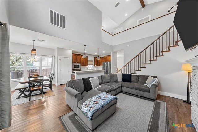 4130 Cripple Creek Dr, Temple, TX 76502 - living area with wood finished floors, stairs, beamed ceiling, high vaulted ceiling, and a fireplace