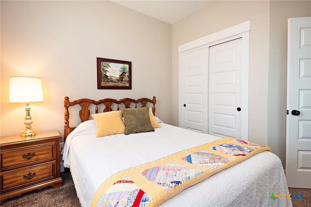 bedroom with dark carpet and a closet