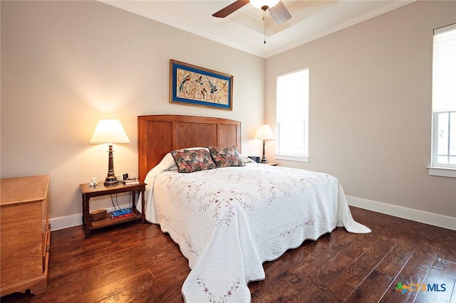 bedroom with dark wood-type flooring, ornamental molding, and ceiling fan