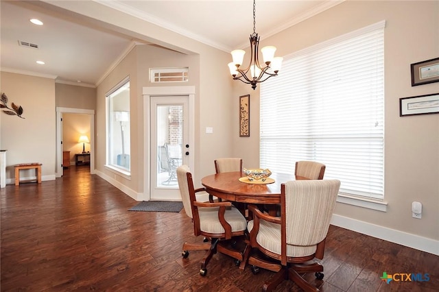 dining room with dark wood-type flooring, plenty of natural light, and crown molding