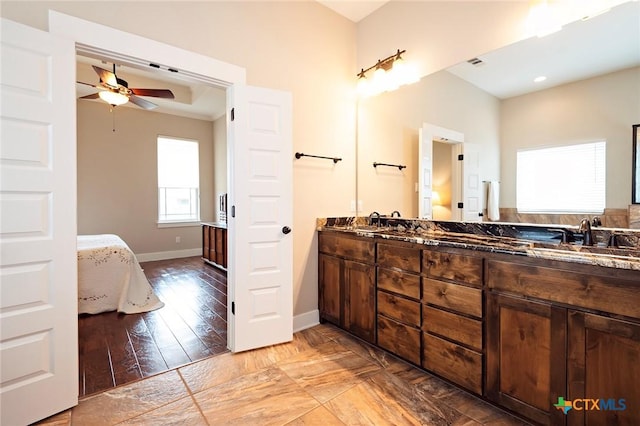 bathroom with hardwood / wood-style flooring, ceiling fan, and vanity