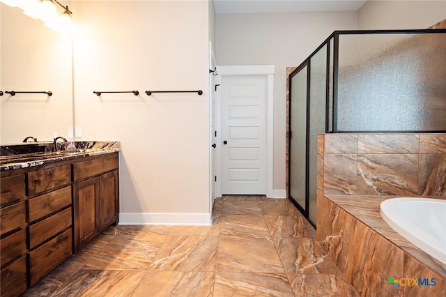 bathroom featuring vanity and independent shower and bath