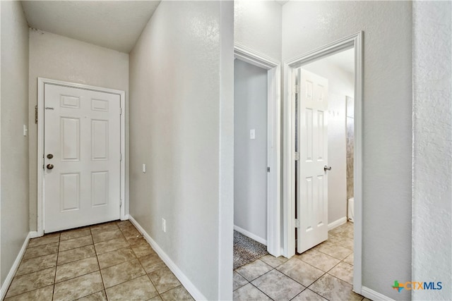 hallway featuring light tile patterned floors