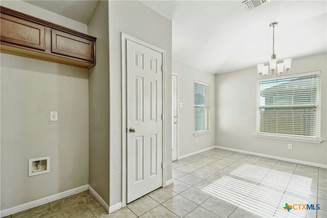 interior space with light tile patterned flooring and a chandelier