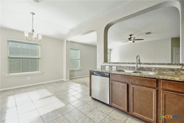 kitchen featuring dishwasher, ceiling fan with notable chandelier, sink, hanging light fixtures, and light tile patterned flooring