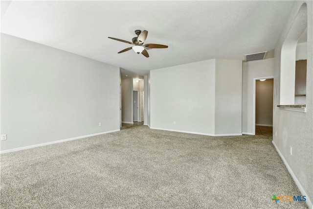 unfurnished room featuring ceiling fan and carpet floors