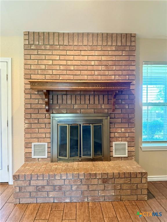 3002 Lois Cir, Copperas Cove, TX 76522 - detailed view of a brick fireplace and wood finished floors