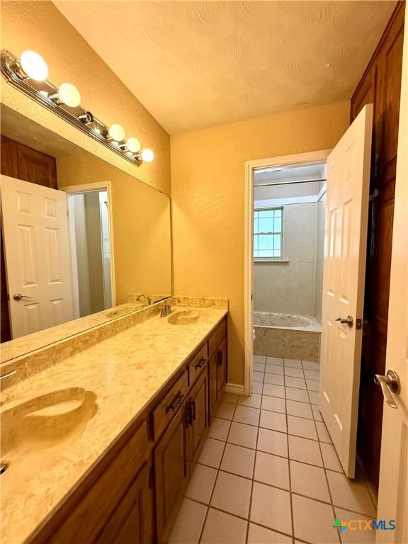 3002 Lois Cir, Copperas Cove, TX 76522 - bathroom featuring tile patterned flooring, double vanity, and a tub