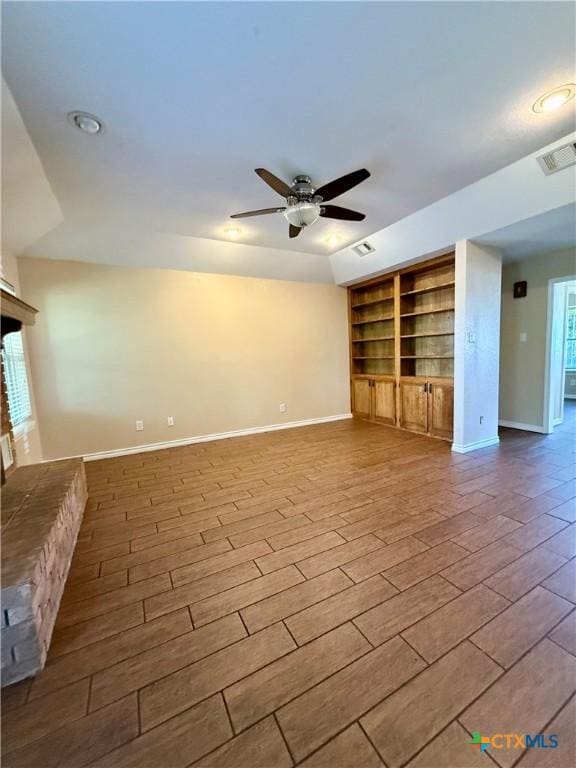 3002 Lois Cir, Copperas Cove, TX 76522 - unfurnished living room featuring built in features, a ceiling fan, and wood finished floors