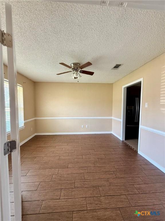 3002 Lois Cir, Copperas Cove, TX 76522 - unfurnished room with ceiling fan, wood finish floors, and a textured ceiling
