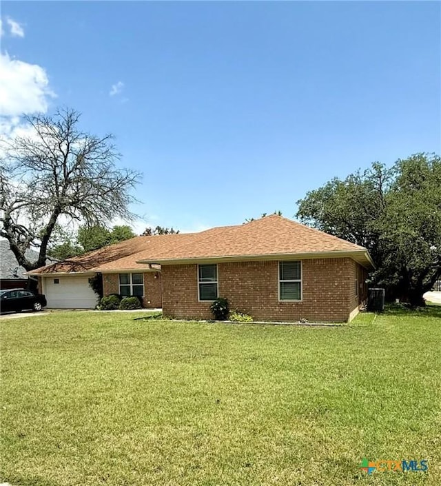 3002 Lois Cir, Copperas Cove, TX 76522 - view of property exterior with a yard, an attached garage, and brick siding