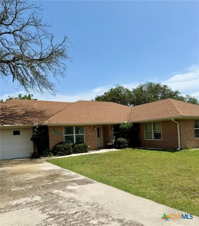 3002 Lois Cir, Copperas Cove, TX 76522 - ranch-style home with driveway, brick siding, a garage, and a front lawn
