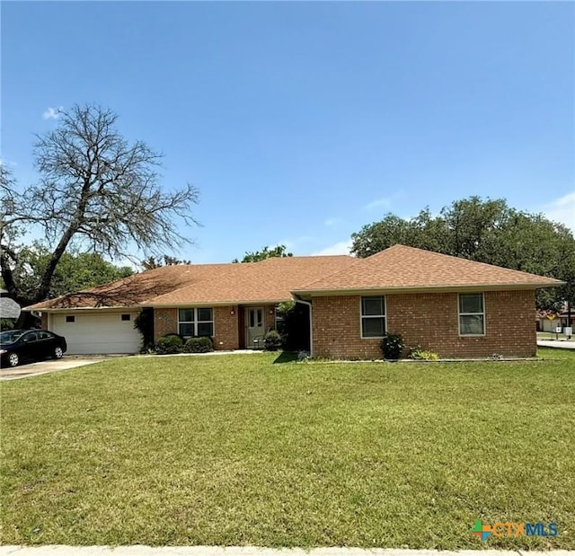 3002 Lois Cir, Copperas Cove, TX 76522 - ranch-style house with a front yard, a garage, brick siding, and driveway