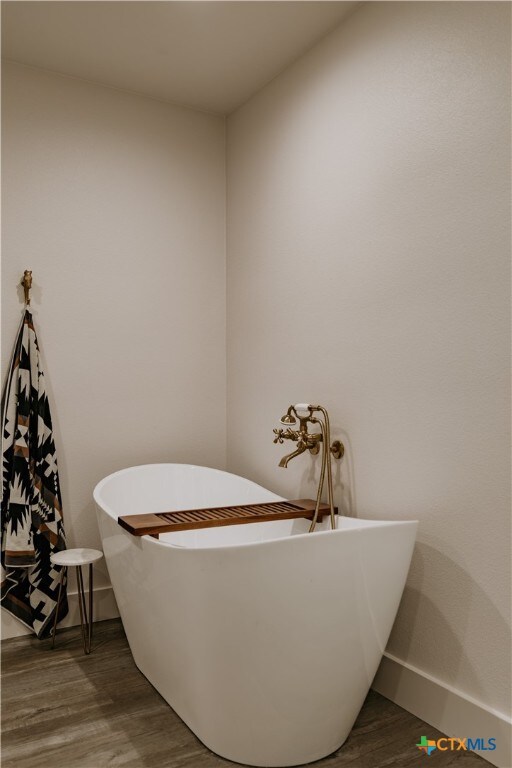 bathroom featuring hardwood / wood-style floors and a bathtub