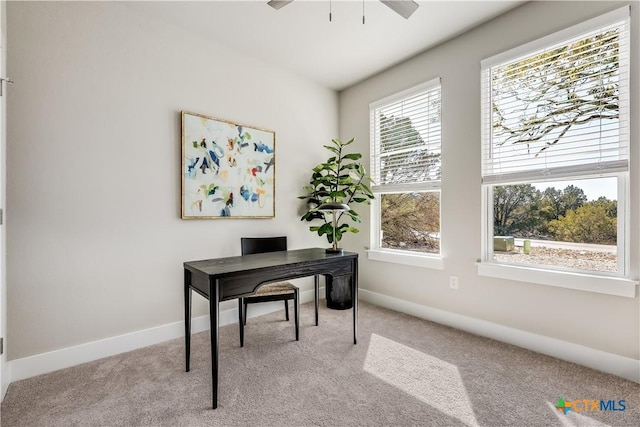 home office with light carpet, baseboards, and a ceiling fan