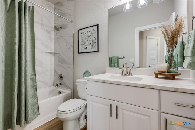 bathroom featuring a textured wall, toilet, wood finished floors, vanity, and shower / tub combo with curtain