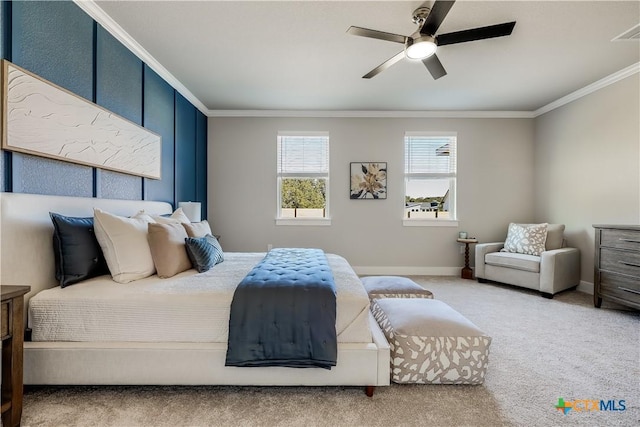 bedroom with carpet flooring, visible vents, baseboards, a ceiling fan, and crown molding