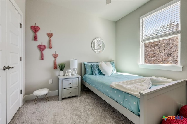 bedroom featuring light carpet and baseboards