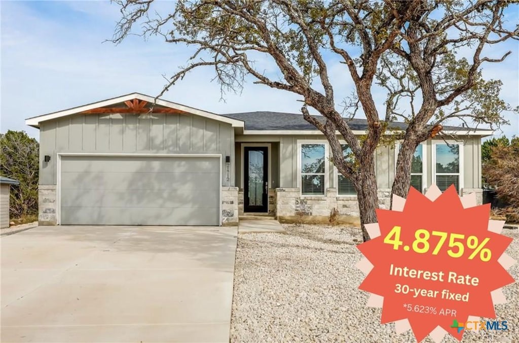 21712 O Henry Ave, Lago Vista, TX 78645 - single story home featuring a garage, driveway, board and batten siding, and stone siding