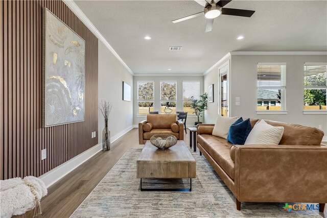 kitchen with appliances with stainless steel finishes, white cabinetry, sink, decorative backsplash, and a kitchen island with sink