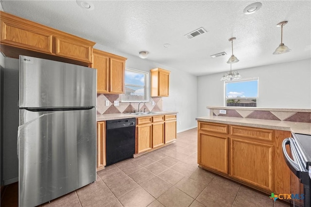 1212 Trailboss Dr, Killeen, TX 76549 - kitchen with freestanding refrigerator, dishwasher, electric range, healthy amount of natural light, and a textured ceiling