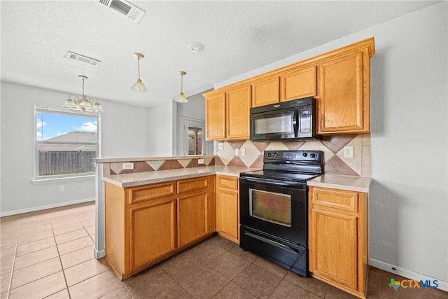 1212 Trailboss Dr, Killeen, TX 76549 - kitchen featuring black appliances, a peninsula, decorative backsplash, light countertops, and a chandelier