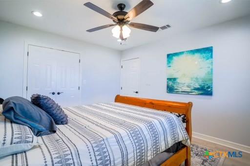 bedroom featuring wood finished floors, ceiling fan, baseboards, and recessed lighting