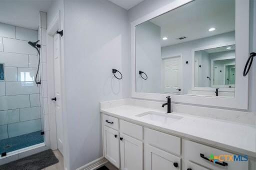 full bath featuring recessed lighting, vanity, and a stall shower