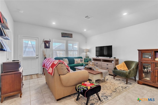 tiled living room with lofted ceiling