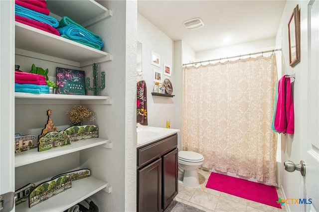 bathroom featuring tile patterned flooring, vanity, curtained shower, and toilet