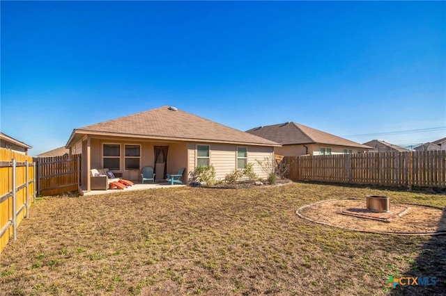 rear view of house with a patio area and a lawn