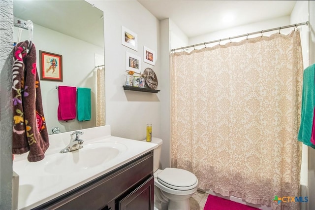 bathroom with vanity, toilet, and a shower with shower curtain