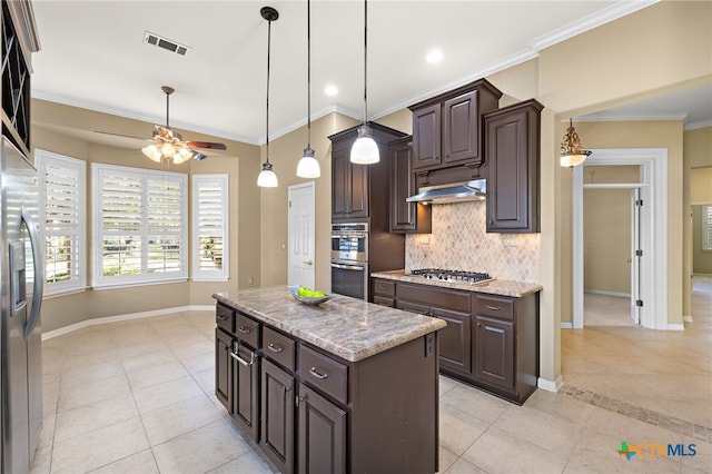 kitchen featuring dark brown cabinetry, light tile patterned floors, stainless steel appliances, and a center island