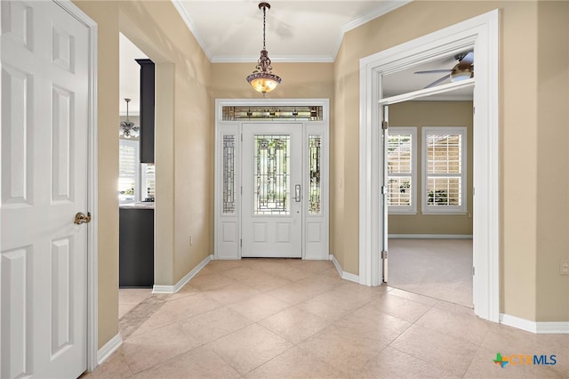 foyer featuring ceiling fan and ornamental molding