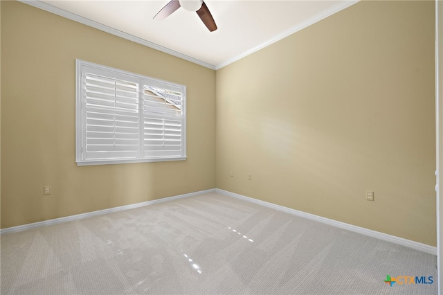 carpeted spare room featuring ceiling fan and ornamental molding