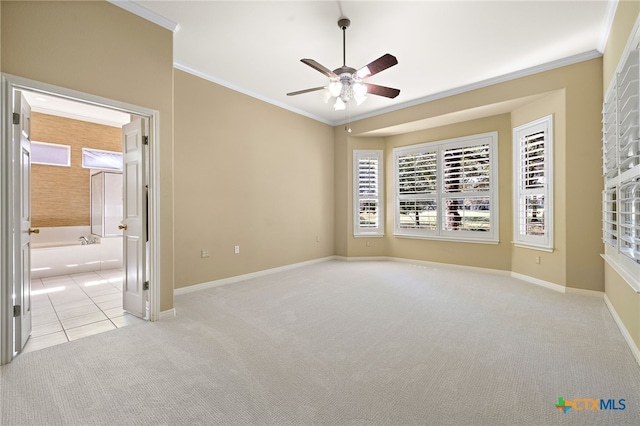 empty room featuring light carpet, crown molding, and ceiling fan