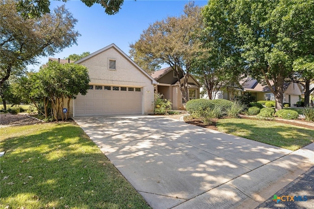 view of front of property with a front yard and a garage