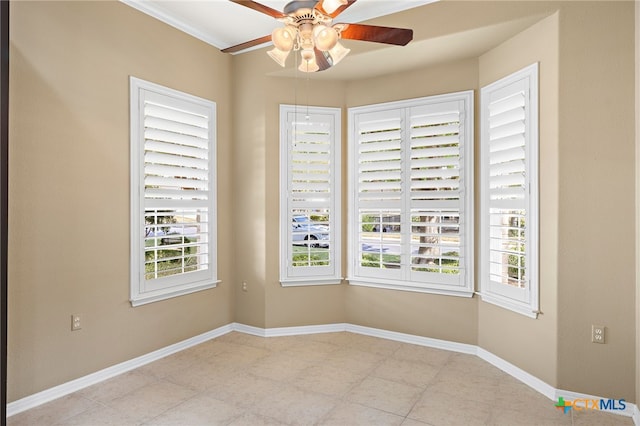 spare room featuring ceiling fan and crown molding