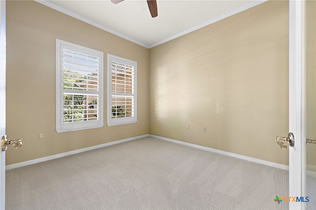 carpeted empty room with ceiling fan and ornamental molding