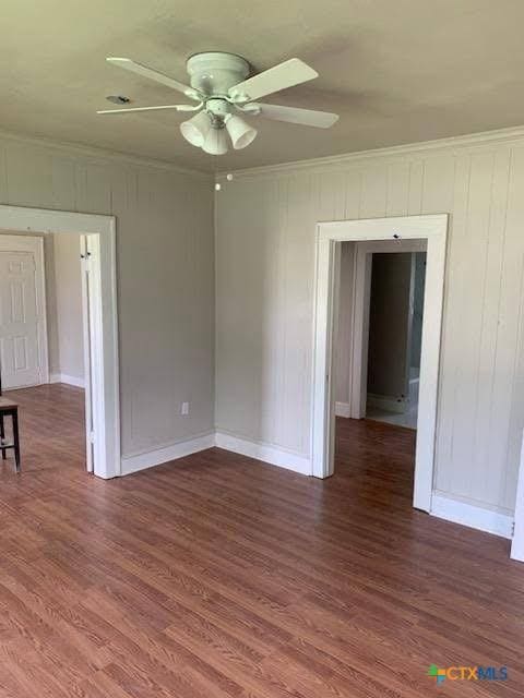 1202 S 7th St, Temple, TX 76504 - spare room featuring ceiling fan, crown molding, wood finished floors, and baseboards