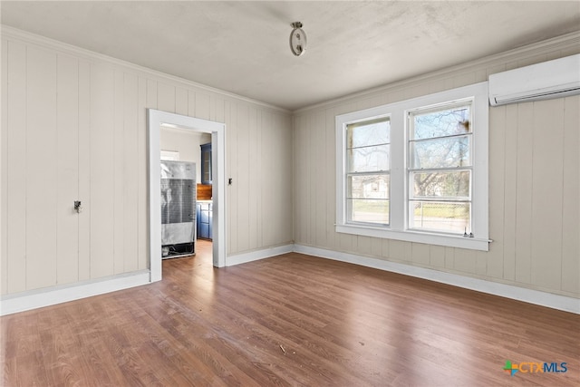 1202 S 7th St, Temple, TX 76504 - unfurnished room with an AC wall unit, wood finished floors, crown molding, and baseboards