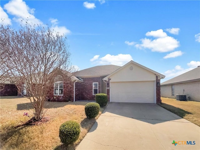 ranch-style home with cooling unit and a garage