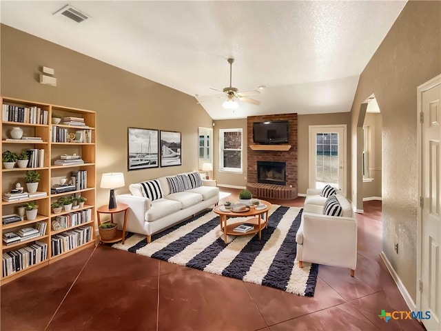 living room with lofted ceiling, a fireplace, ceiling fan, and plenty of natural light