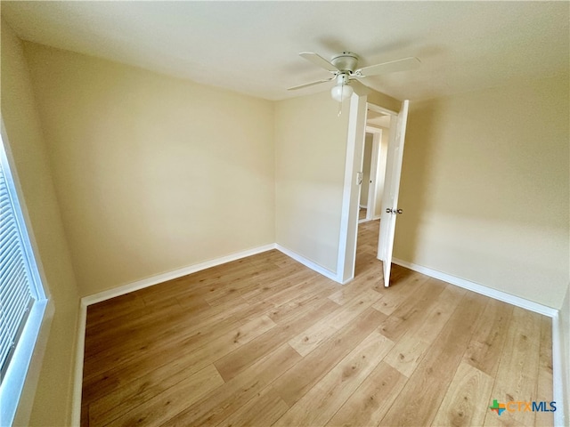 spare room featuring light wood-type flooring and ceiling fan