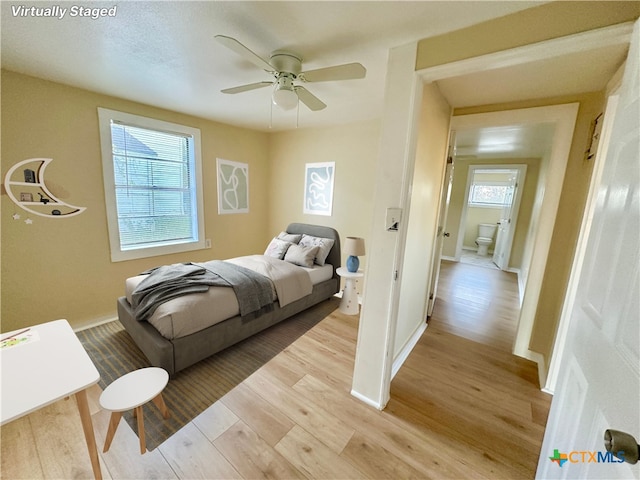 bedroom featuring light hardwood / wood-style flooring, multiple windows, and ceiling fan