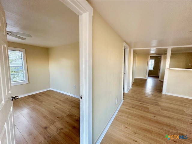 corridor with light hardwood / wood-style flooring