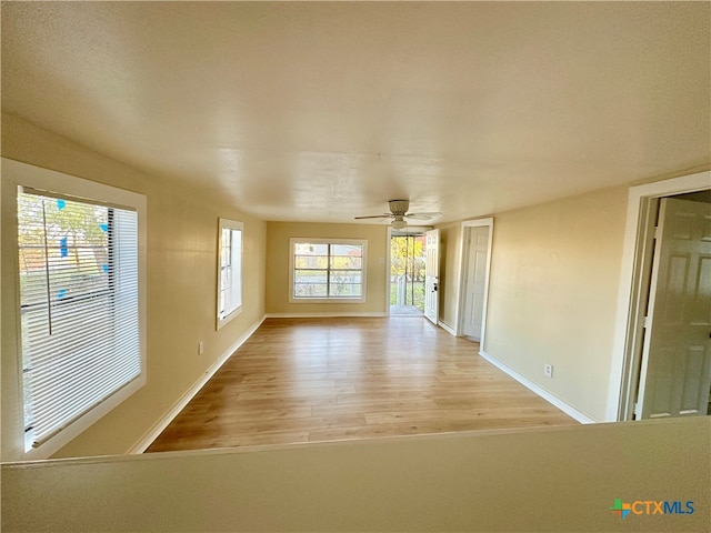 spare room featuring ceiling fan and light wood-type flooring