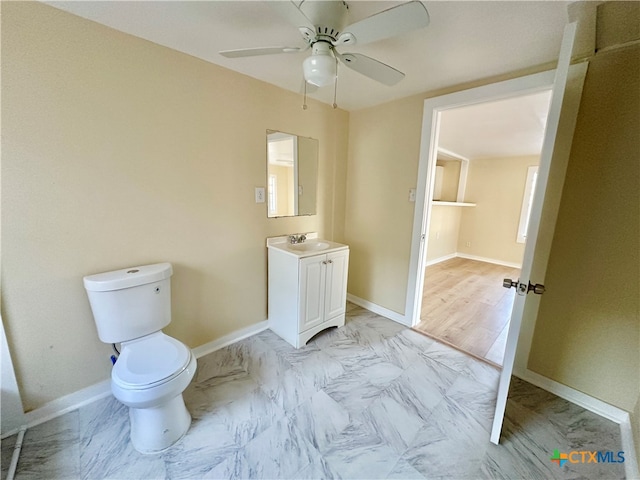 bathroom featuring ceiling fan, hardwood / wood-style floors, vanity, and toilet